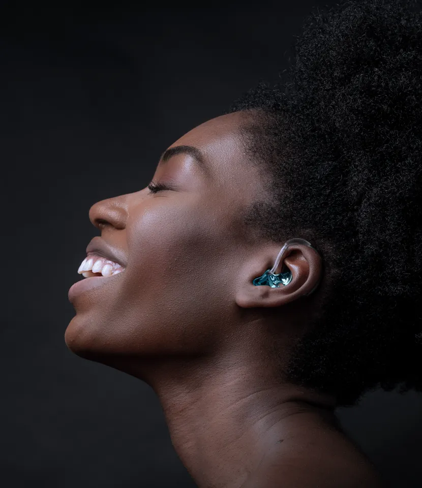 Model shows joy about a titanium earmould